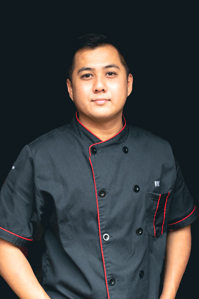 A man in a black chef uniform